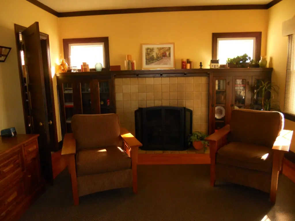 Fireplace with Rookwood tile and built in bookcases on both sides
